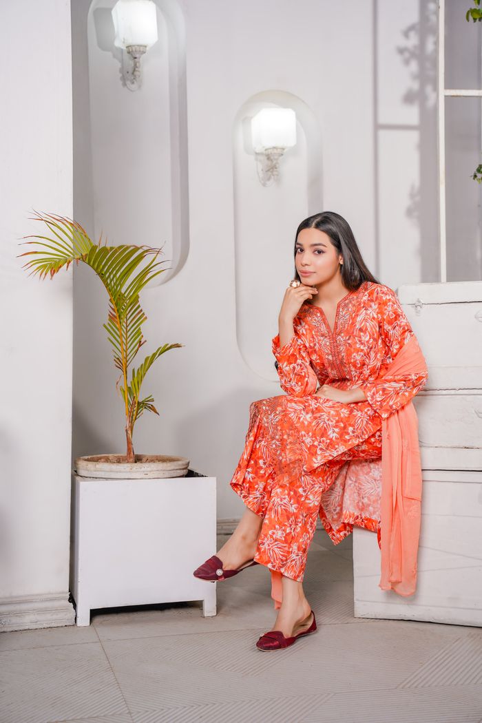 Mastering the First Impression: Your intriguing post title goes here A stylish woman in traditional Pakistani clothing in a modern indoor setting.